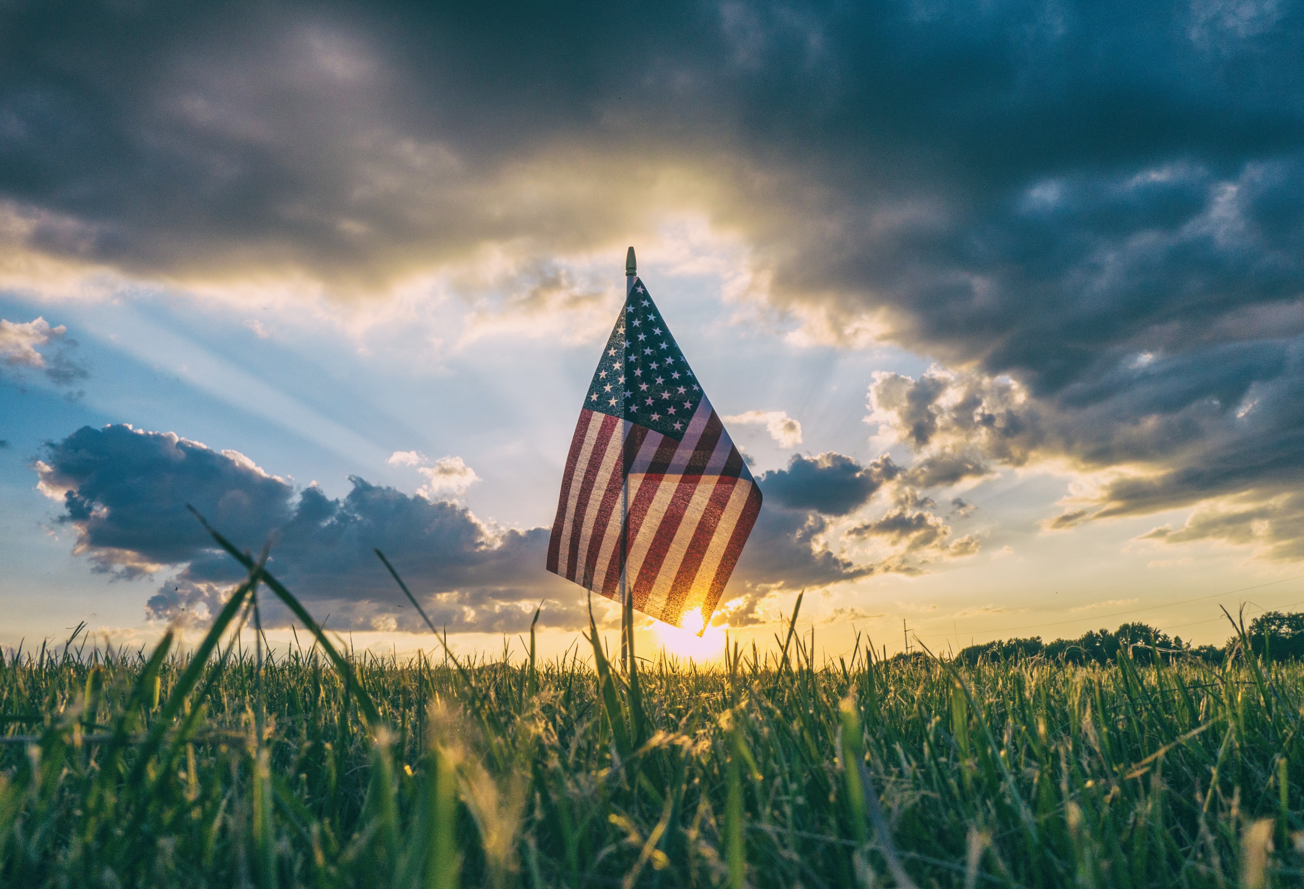 American flag on grass in sunset