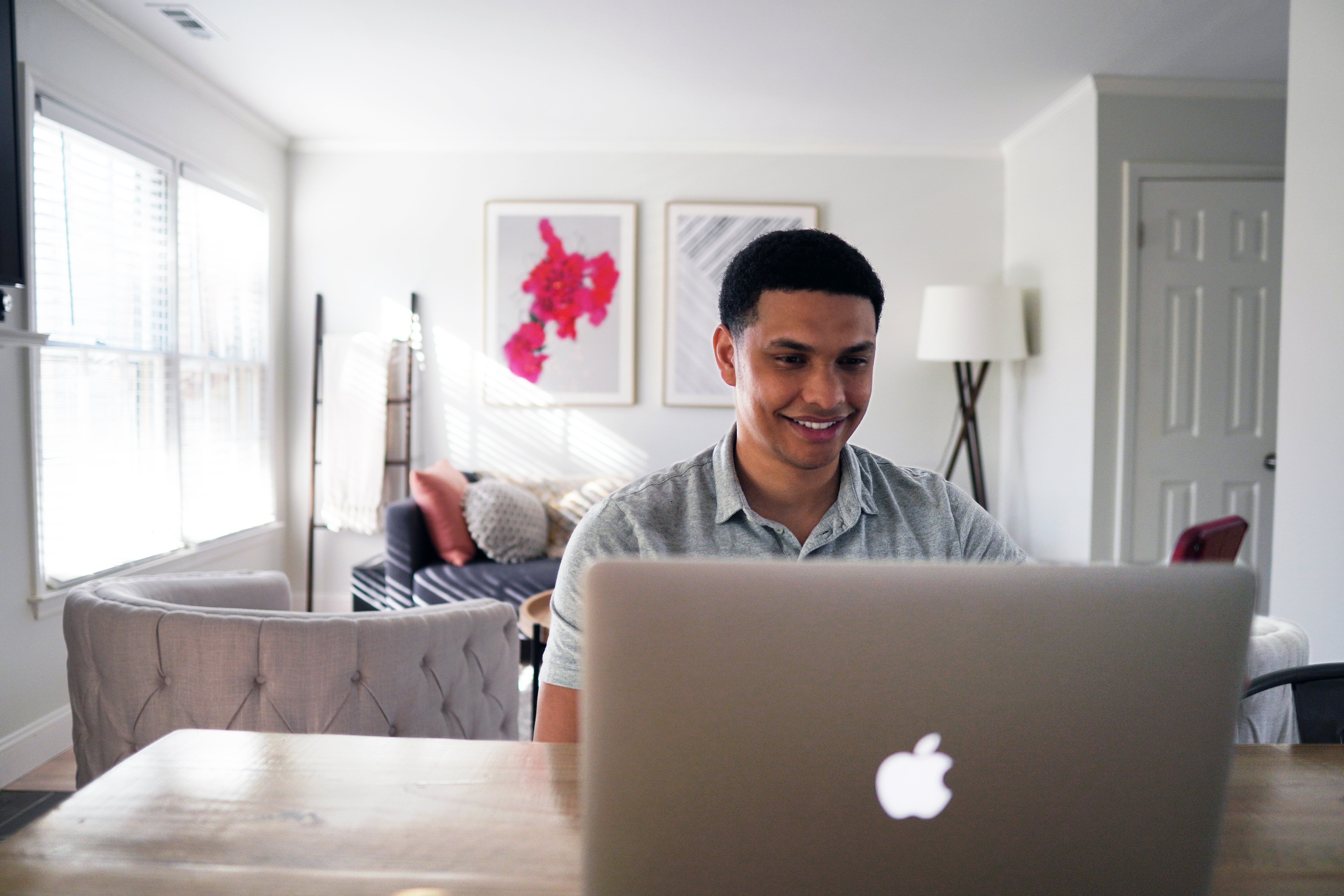 person smiling looking at laptop